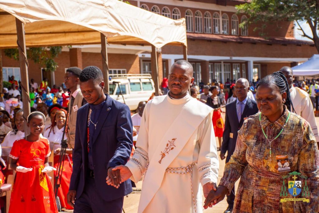 Fr Gift escorted by his parents