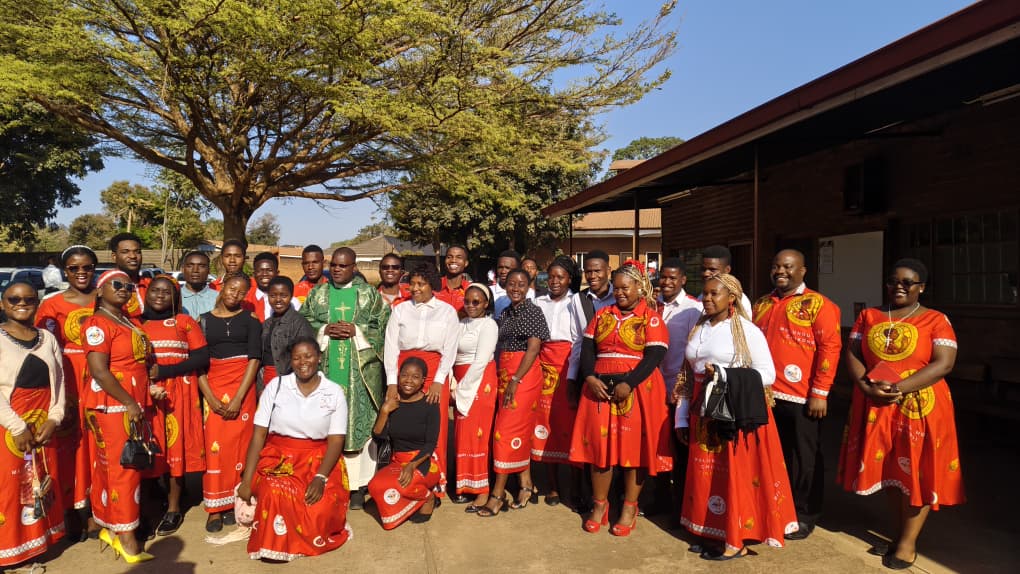 St Kizito Parish Youth with Fr John Mangwere after Mass