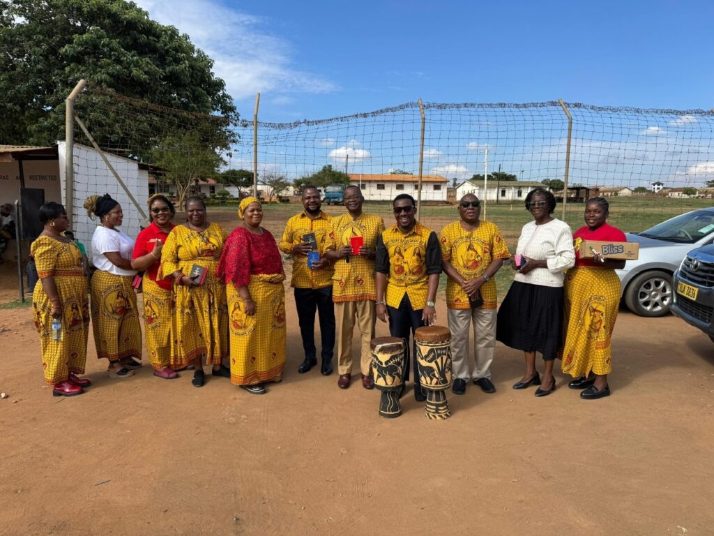 St Emmanuel of St Kizito at Maula Prison present hymn books and drums to Maula Prison