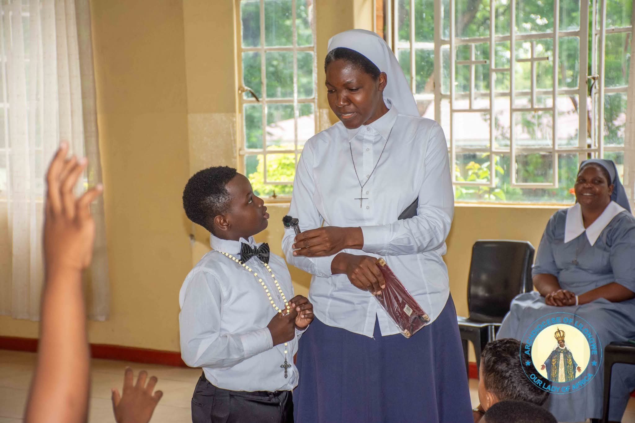 a sister conducts a quiz with the children