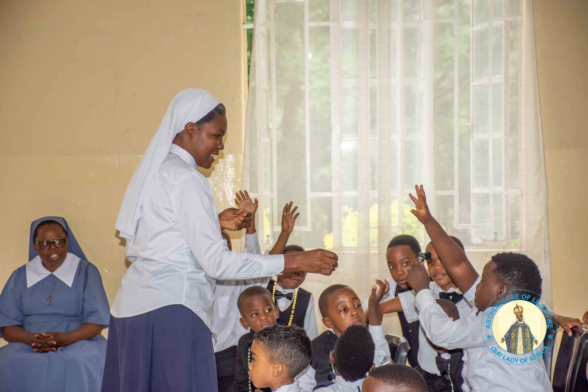 a sister conducts a quiz with the children