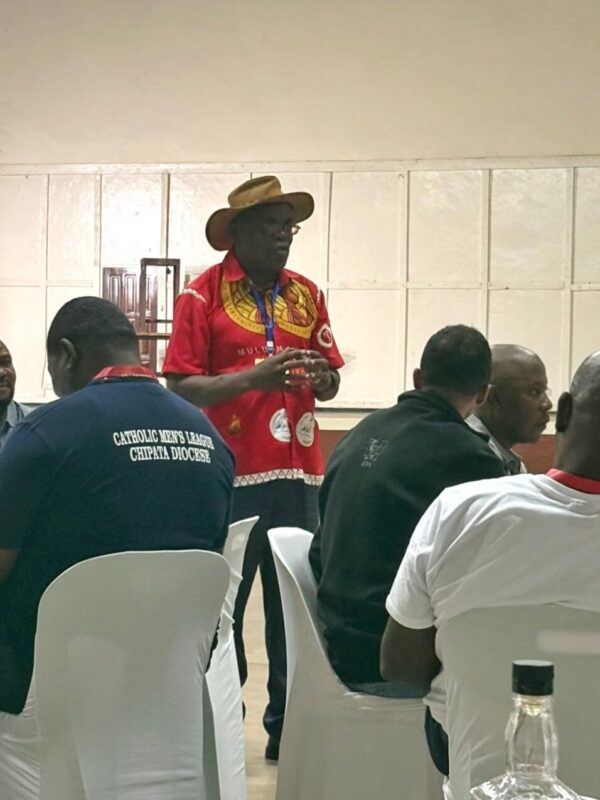 parish vice chair clement stambuli welcoming catholic men's league members to st kizito parish