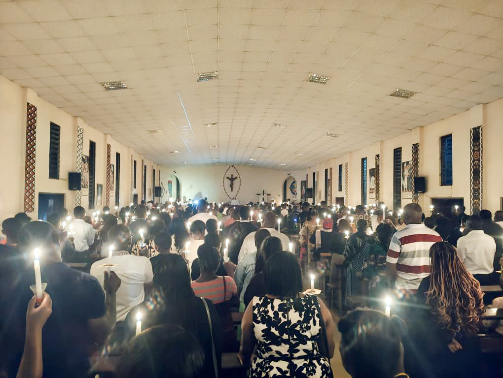parishioners with lit candles in church